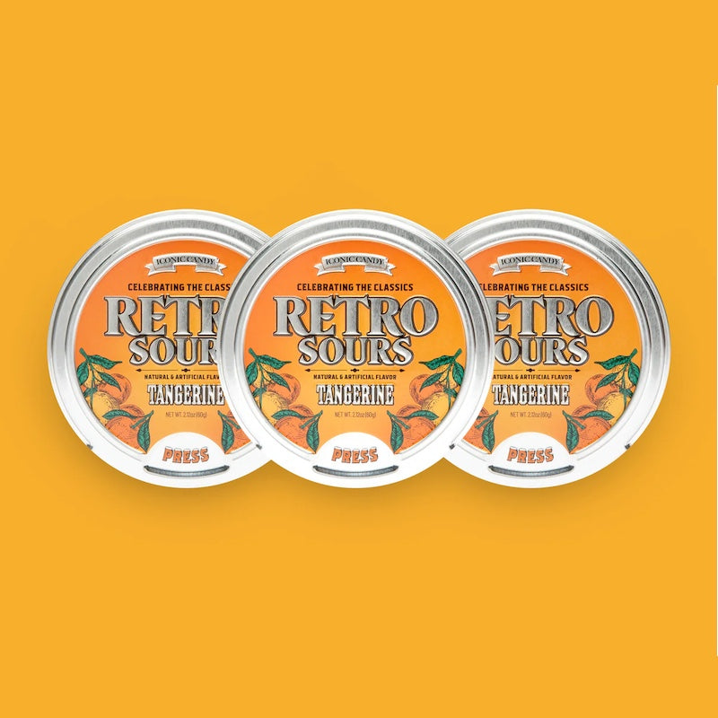 Three tins of Retro Sours Tangerine hard candies.